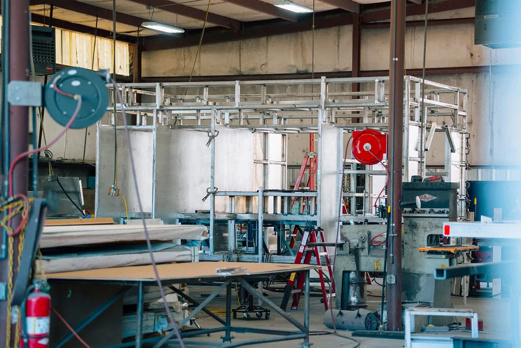 Sheet metal staged at the shear on the FES fabrication floor